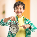 kid holding a clock